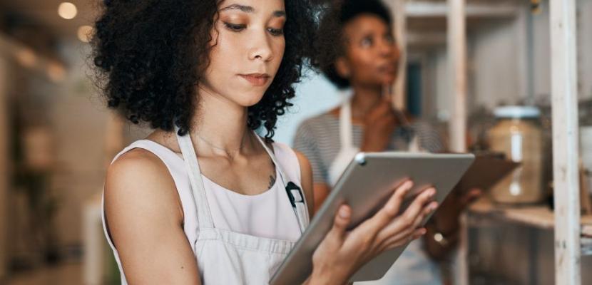 Women Standing in a new business premises looking at a Tablet 