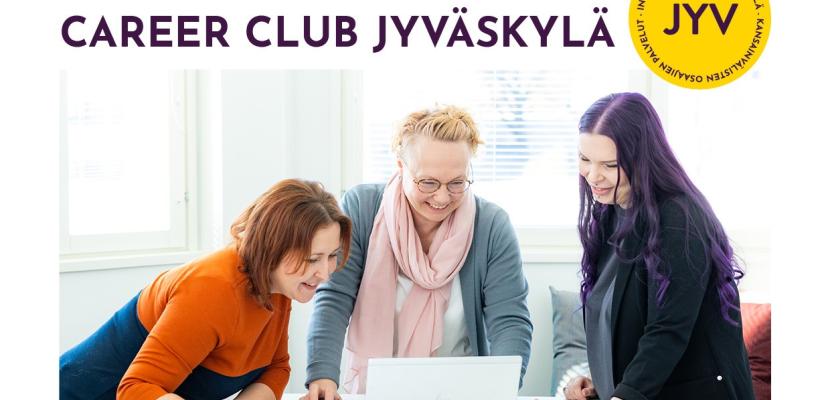 Three women around a laptop