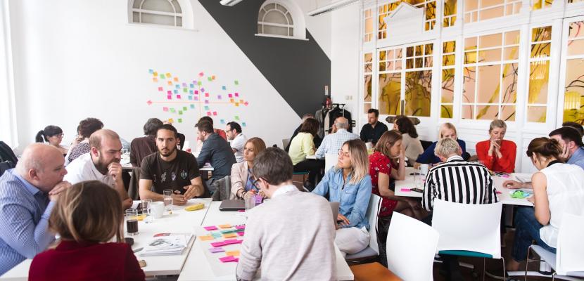 Group of people sitting at table and working