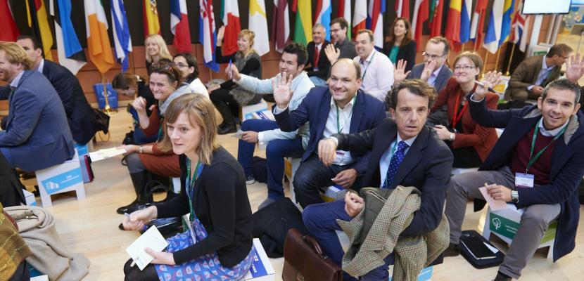 People sitting and raising hands