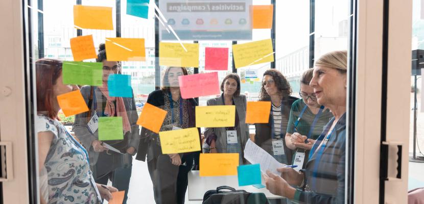 workshop participants looking at colourful post-it notes