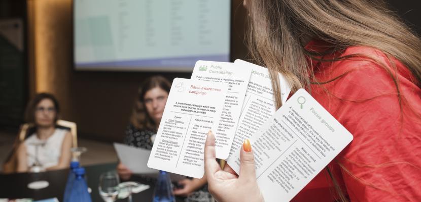 Woman holding up cards