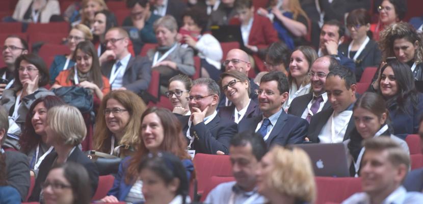 event participants seated in the audience of a plenary session