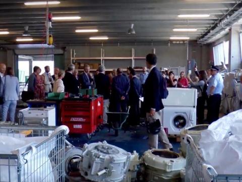 People inside a plant for electrical and electronic waste