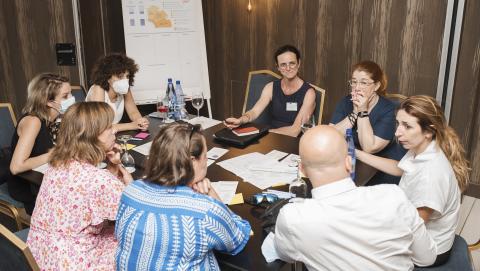 People around a table and working together People around a table and working together