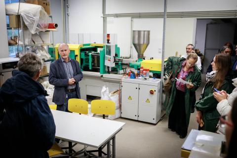 A group are shown a testing lab for wood products. 