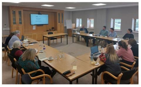 People seated around a meeting room table