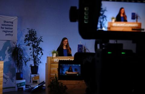 Shot of communication team member behind the camera at Europe, let's cooperate event. Behind the camera shot inside studio