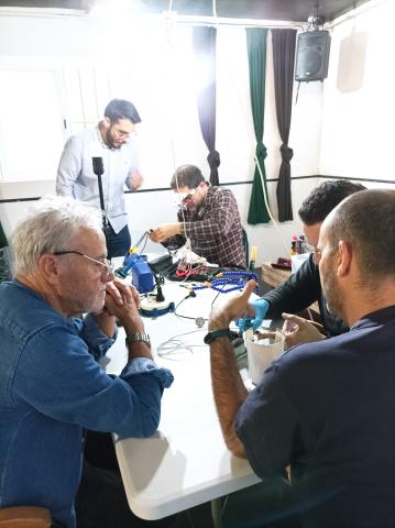 Repair cafe where people learn how to fiz their home equipments such as coffee machines