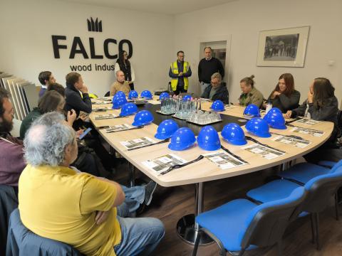 A group are breifed on a factory visit, at Falco, Szombathely.