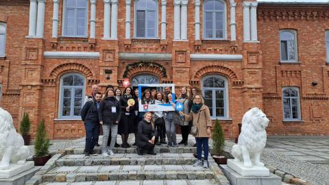 Project partners standing in front of the building during the kick-off meeting in the city of Nowy Dwór Mazowiecki.