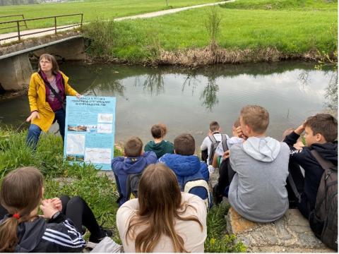 Kids studying outside in front of a river