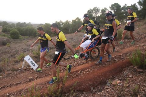 Volunteers with person with disabilty hiking in natural protected areas