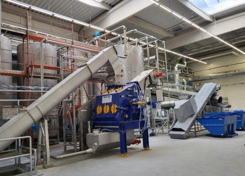  Industrial facility with machinery for processing bio-waste into energy and products.