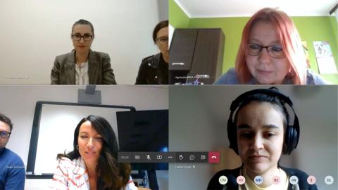 A screenshot of an online meeting with six participants visible in separate video windows. Participants are engaged in discussion, with some wearing headsets and others sitting in their respective office spaces.