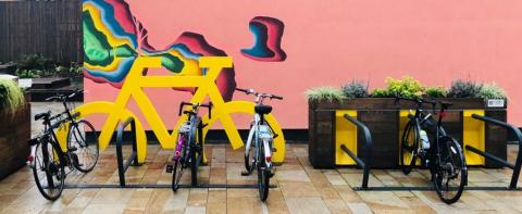 Row of bike in front of a colorful wall Row of bike in front of a colorful wall
