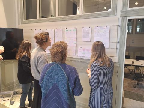 A group of people discuss in front of a panel