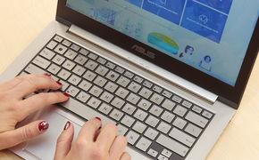 person writing on a laptop person navigating throug interreg's europe website