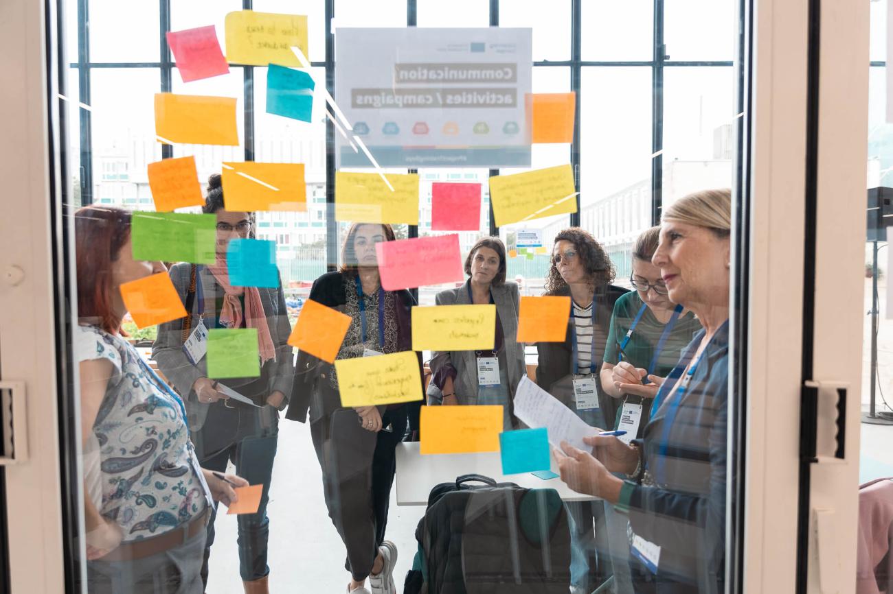 workshop participants looking at colourful post-it notes