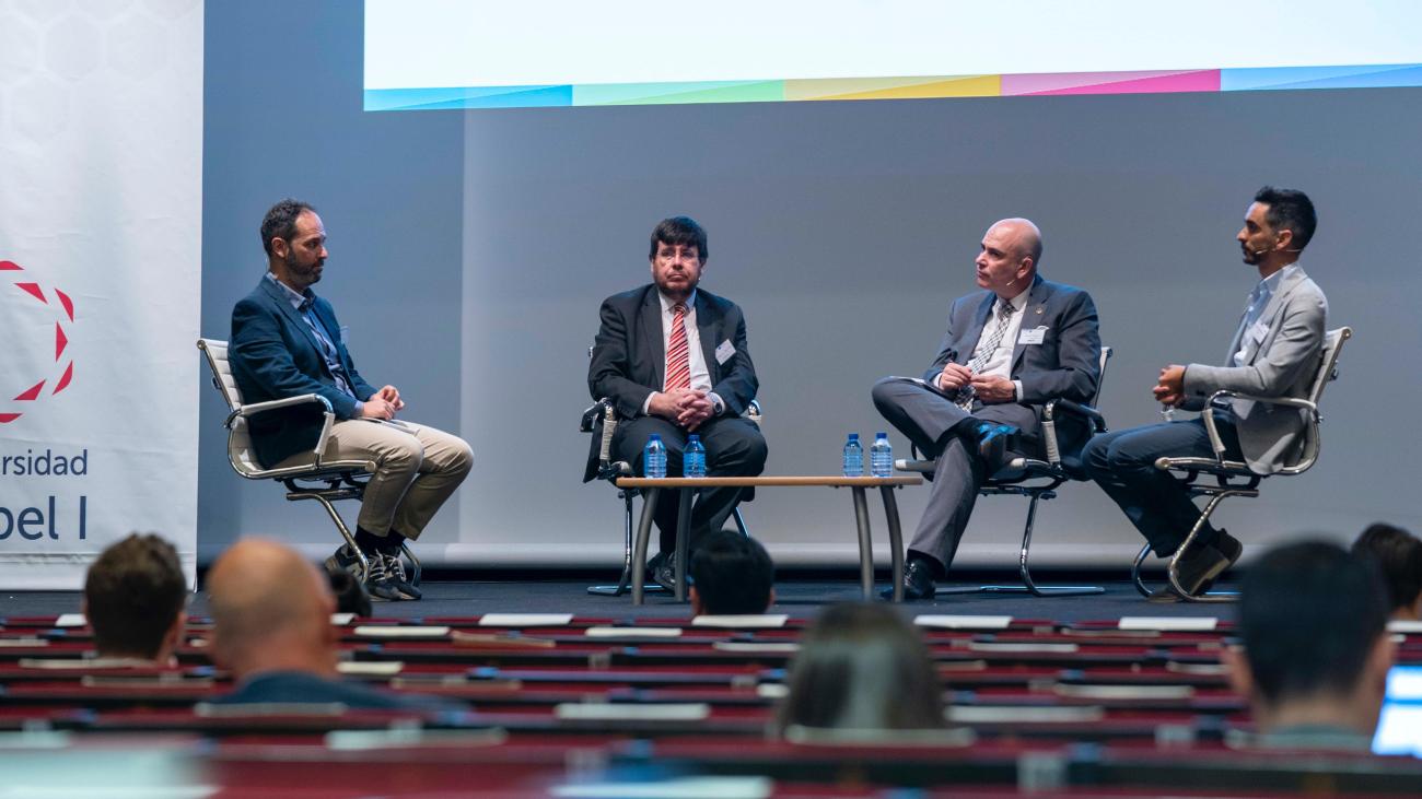 4 people talking on a stage