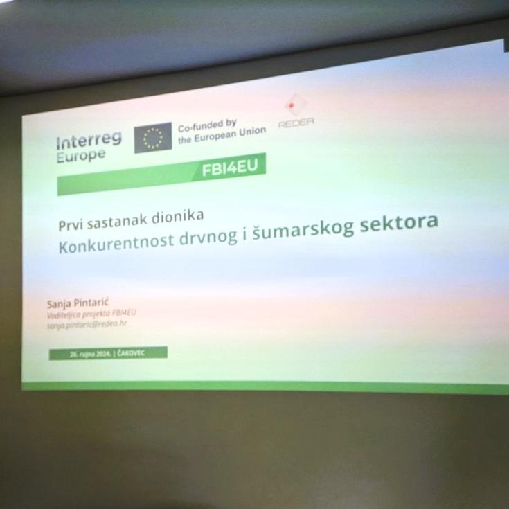 A slide presentation displaying the title "Prvi sastanak dionika" (First Stakeholder Meeting) with a focus on the competitiveness of the wood and forestry sector, part of the FBI4EU project co-funded by the European Union and organized by REDEA. The presenter's name and contact information are visible, along with the date and location: "26. rujna 2024., Čakovec."