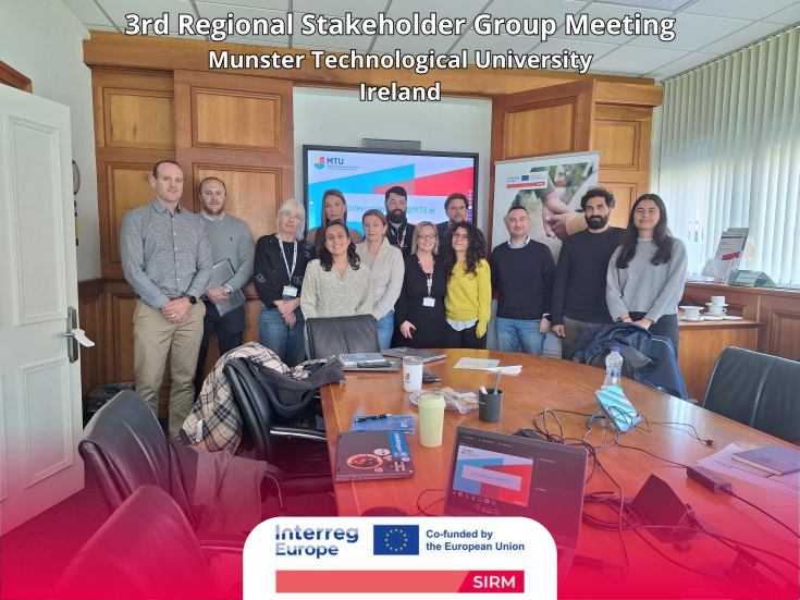 Meeting participants posing for a photo in the conference room.