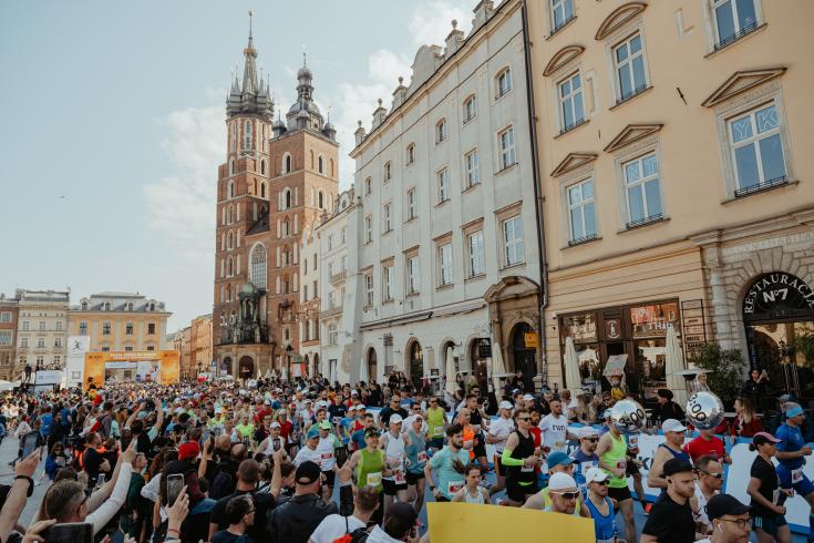 Group of people running a marathon in the city of Kraków