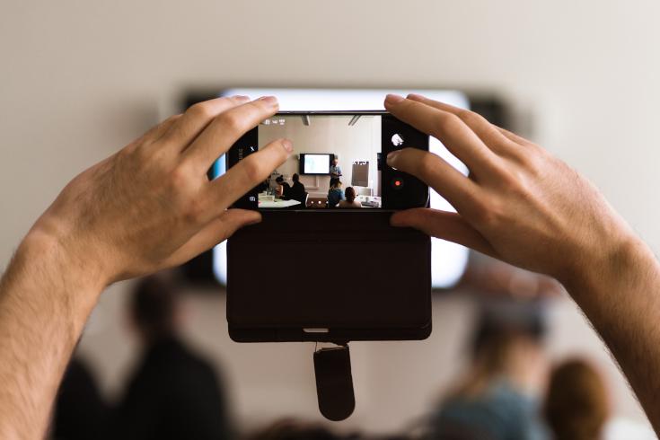 Person taking photo during event 