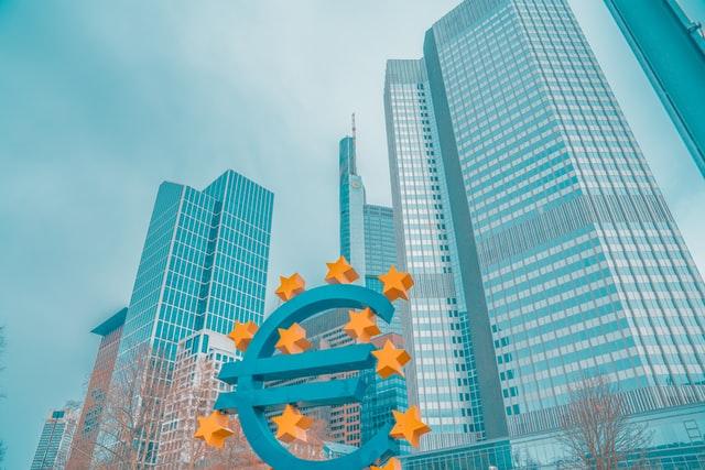 Euro sign in front of highrise buildings