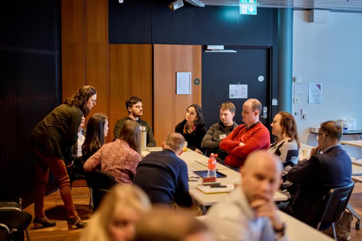 Group of people speaking around a table