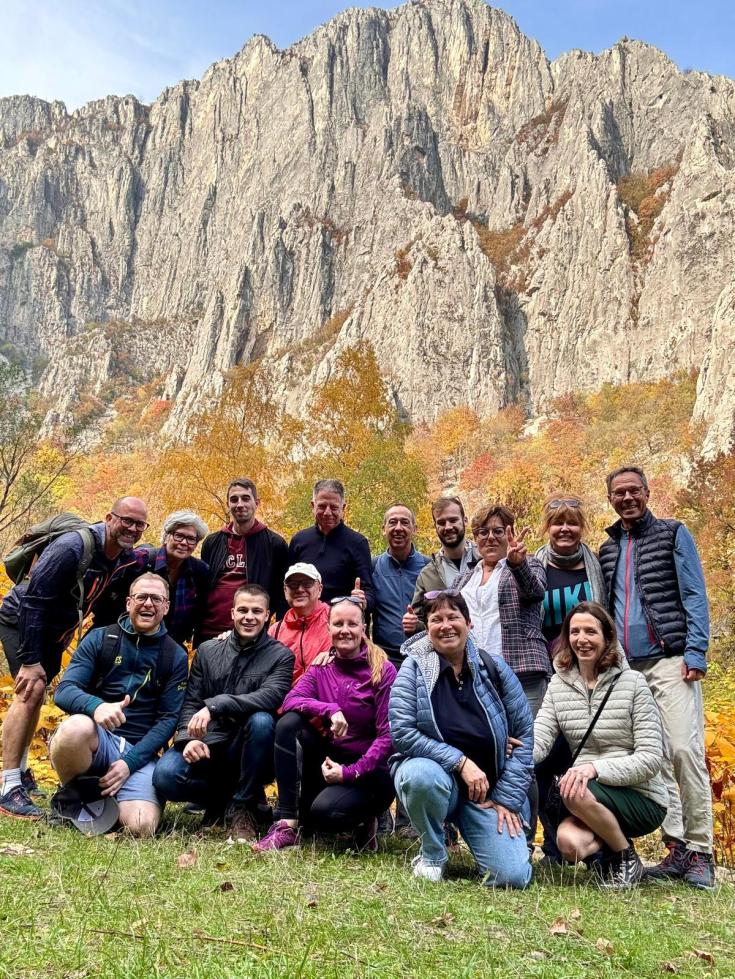 Picture of project partners posing in front of a mountain 