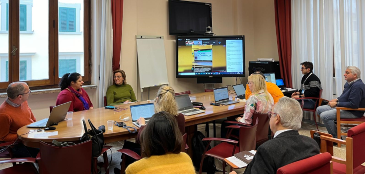 People attending a meeting with screen