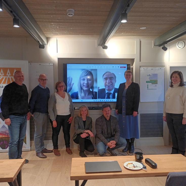 Project partners gathered for a group photo in a meeting room