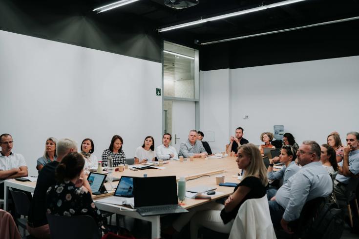 People at table listening to presentation