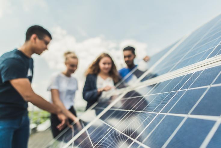 People looking at solar panels