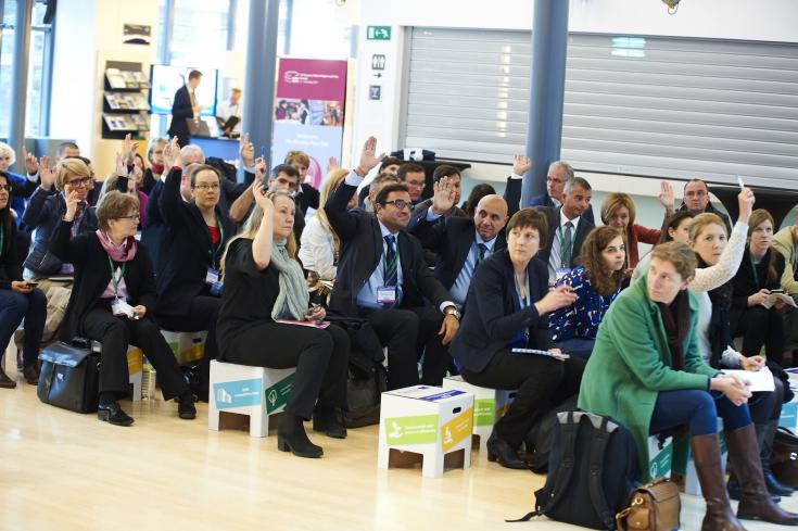 People sitting on stools during event