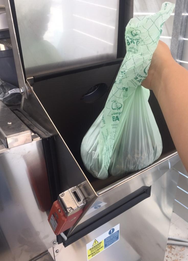 Person dropping waste in machine