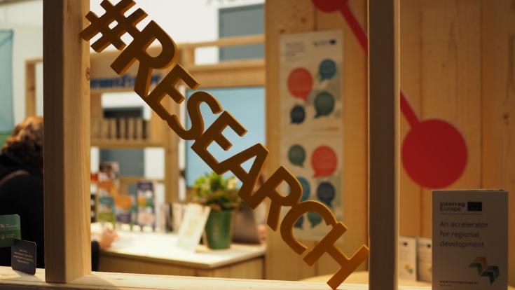 #Research The word research in wood placed in front of a window