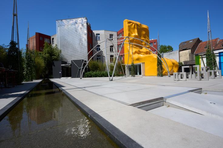 Square with modern buildings and pond