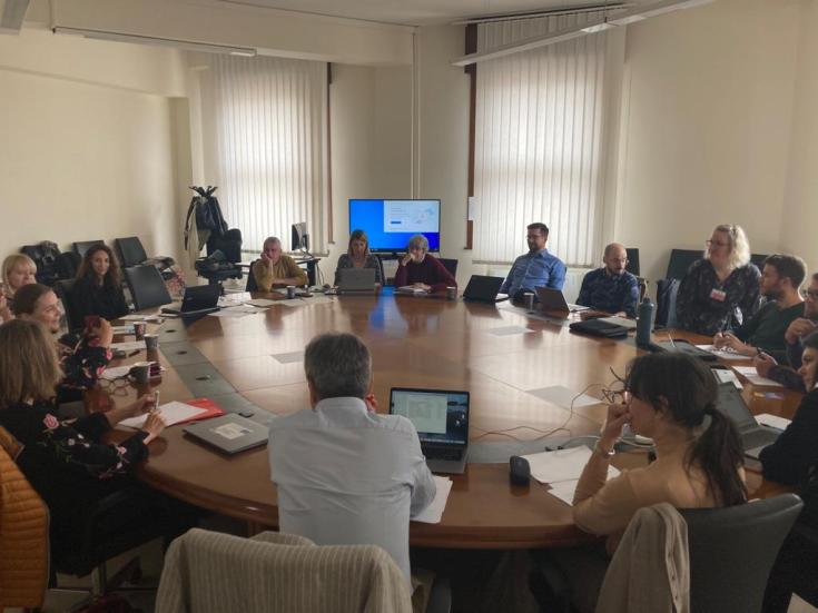 people aroun t a table discussing about renewable energy communities