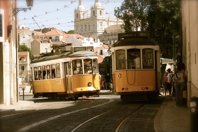 Two yellow trams in a city