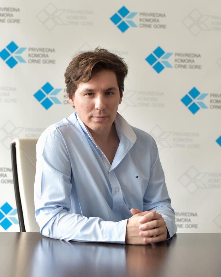 A man sitting on a table looking at the camera