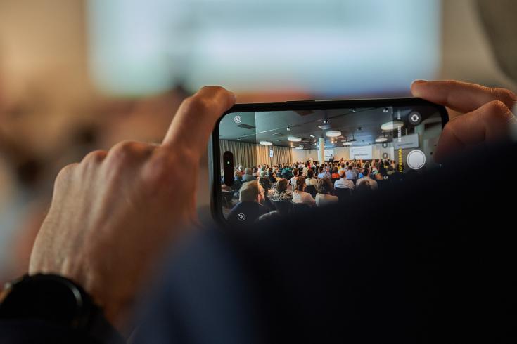Person taking photo at event Person taking photo at event