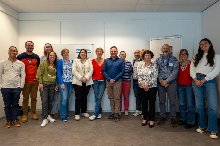 Stakeholders stand in a row for a group photo