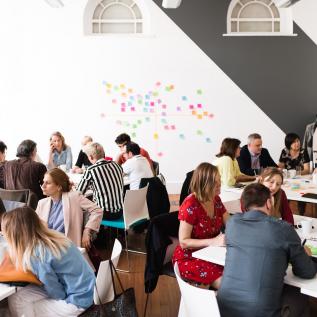 People working in groups on post-its People working in groups on post-its