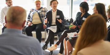 People sitting in a circée and discussing People sitting in a circée and discussing
