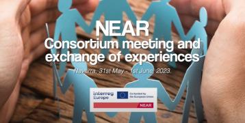 Paper people holding hands with encircling hands around them. Text: "NEAR - consortium meeting and exchange of experiences - 31st of May - 2nd of June