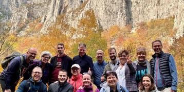 Picture of project partners posing in front of a mountain 