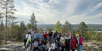 DEBUTING project group at Ounasvaara hill, Rovaniemi, Lapland. With midnight sun in the back.