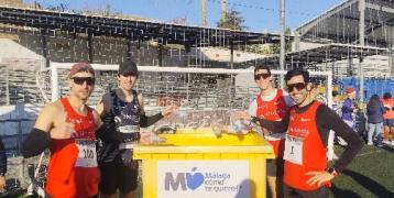 Runners having their photo taken around a waste container